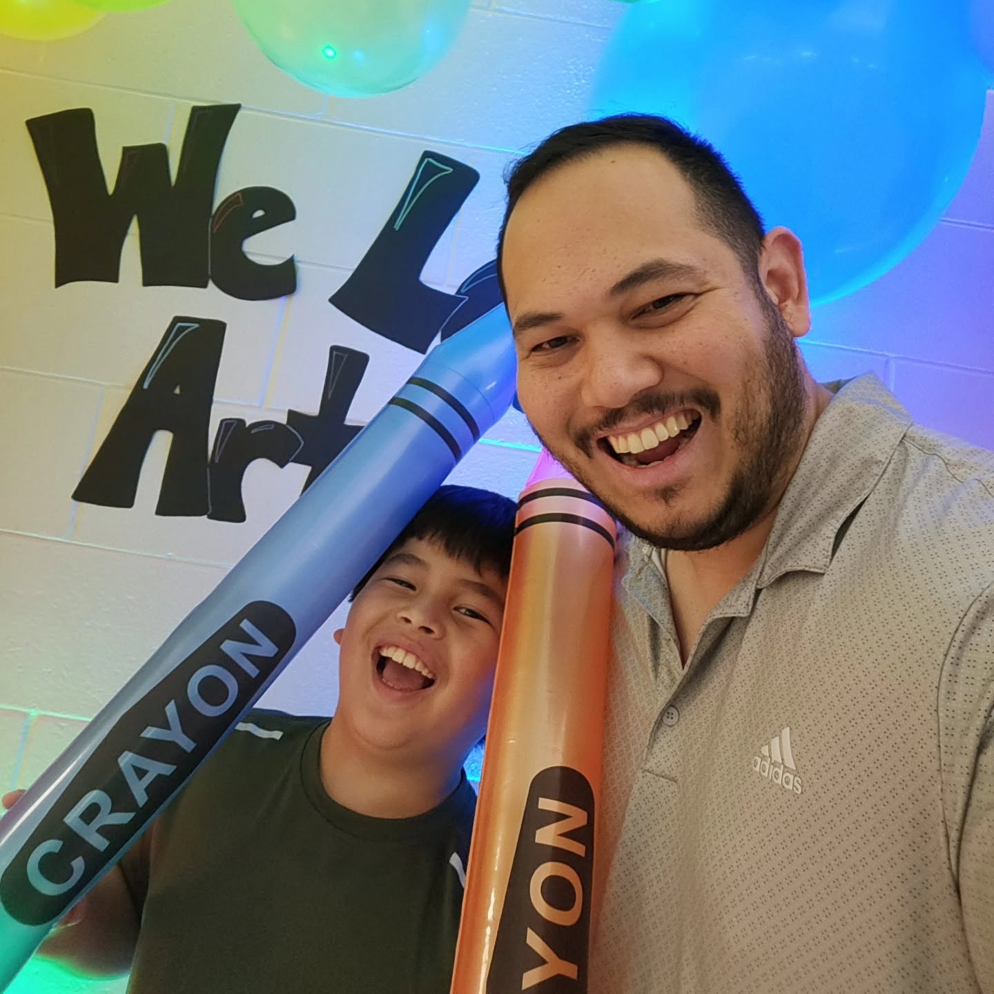 Jonathan Deleon with his son at a family art event